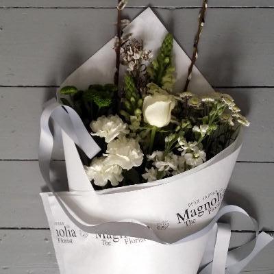 Cambridge Bouquet - Magnolia the Florist This bouquet is the perfect choice for any occasion. Expertly crafted in a traditional wrapped style, the Cambridge Bouquet from Magnolia the Florist, features a stunning blend of white and green flowers. Please note that flower selection may vary based on availability but normally would feature roses, alstroemeria, antirrhinums, chrysanthemum, carnations and gyp.  1