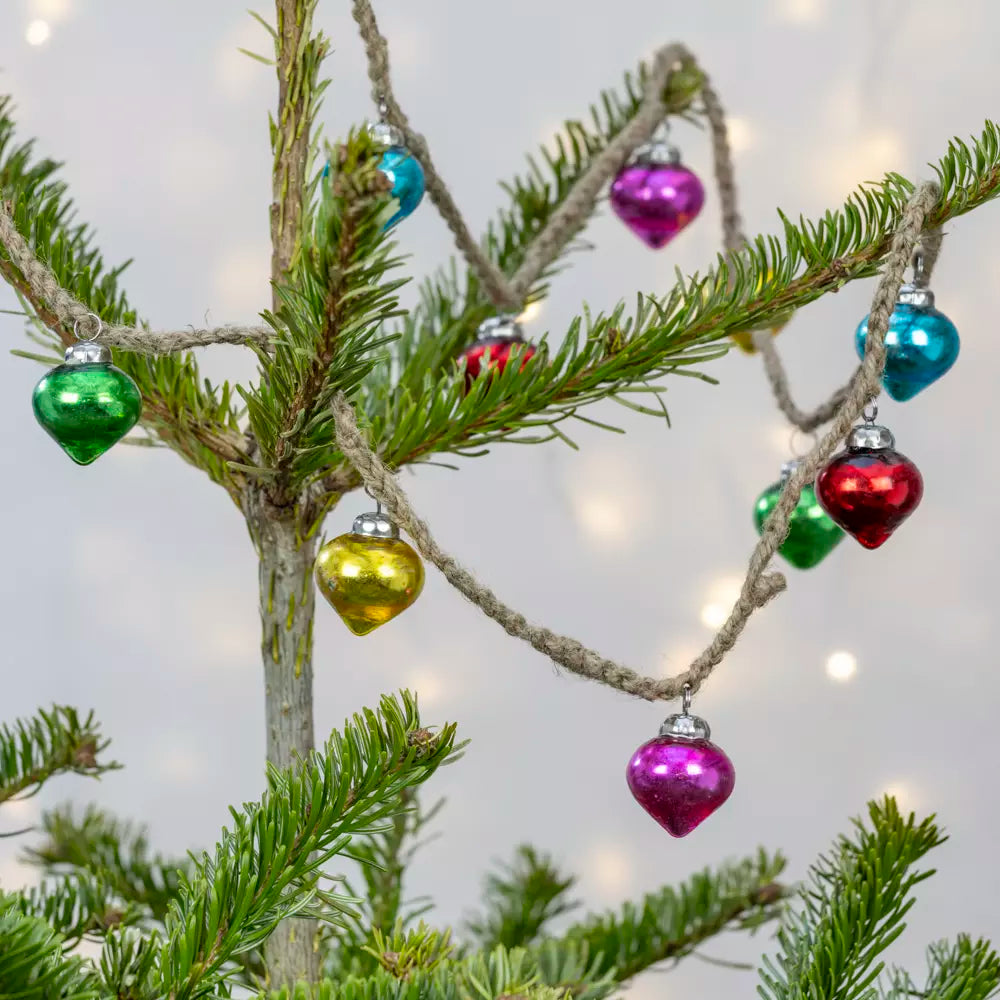 Rainbow Bauble Garland - 160cm - Magnolia the Florist Add a splash of colour to your holiday décor with our mini bauble garland. Featuring a delightful mix of pink, turquoise, gold, and green baubles, this charming decoration is perfect for brightening up any space. Ideal for draping across mantels, staircases, or around your Christmas tree, it brings festive cheer in an instant. Dimensions: 160 cm - Glass  3