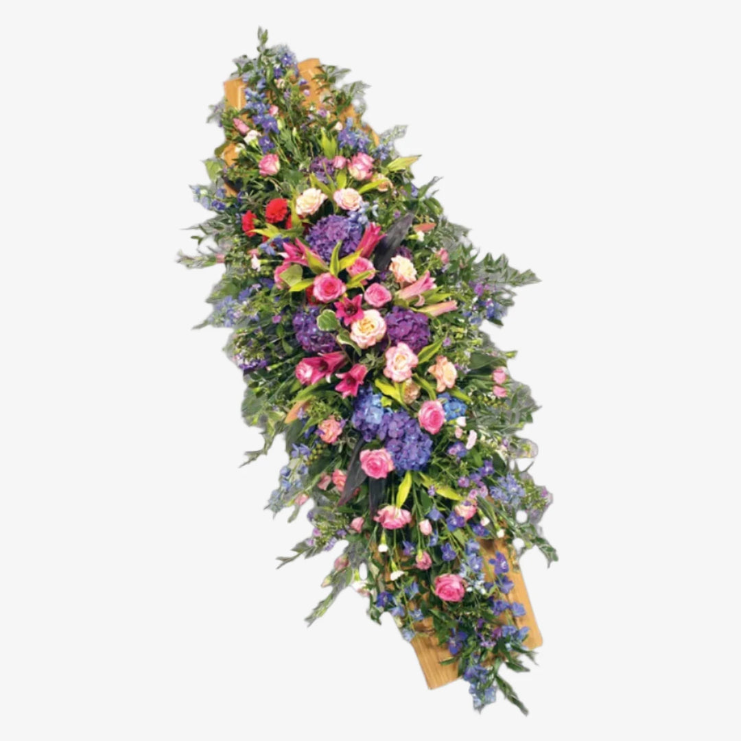 Mauve & Pink Casket Spray - Magnolia the Florist A stunning casket spray in beautiful pinks, Lilacs and blues. Roses, Hydrangea, Lilies and Carnations with luscious green foliage. If you cannot find what you want on our site, please call our sales team, we're always happy to assist you. This item requires 2 days notice to order.  1