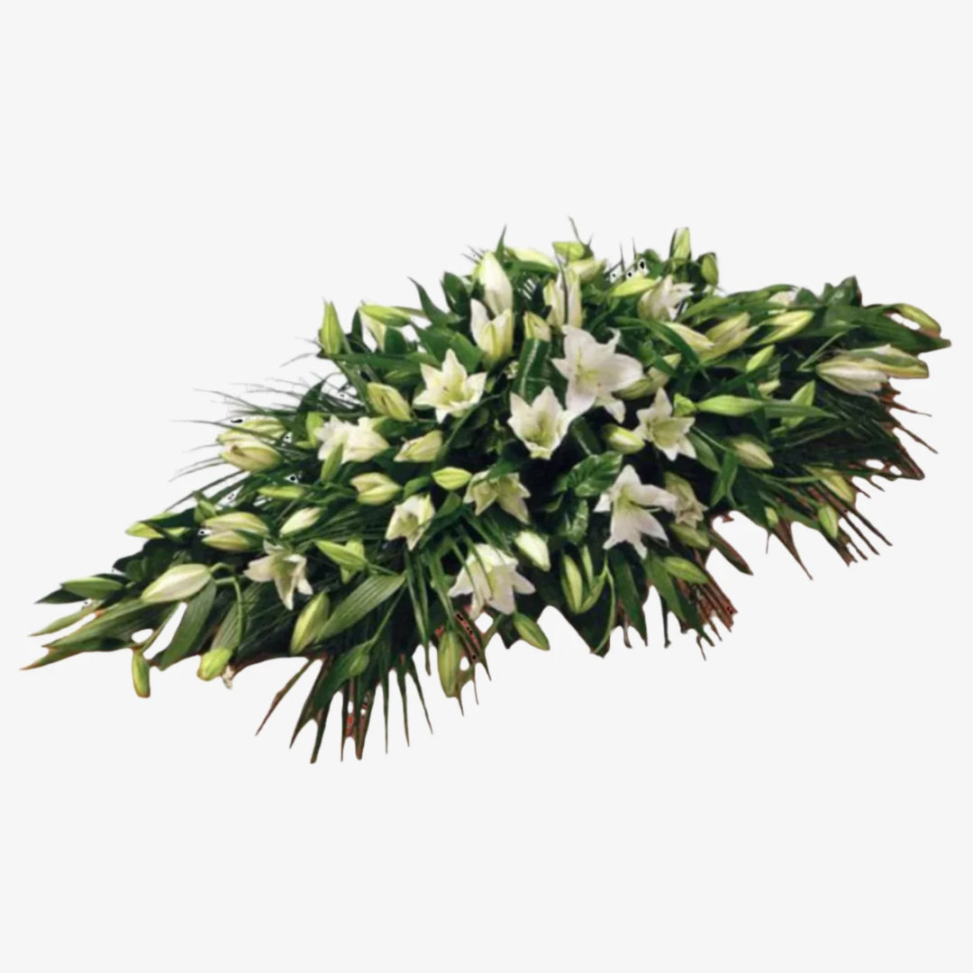 Lily Casket Spray - Magnolia the Florist Oriental Lilies are beautifully set off by an array of luxurious deep green leaves to create this simple but striking Lily Casket Spray. You also have the colour options of White or Pink. The image shows the White option. If you cannot find what you want on our site, please call our sales team, we're always happy to assist you. This item requires 5 days notice to order.  1