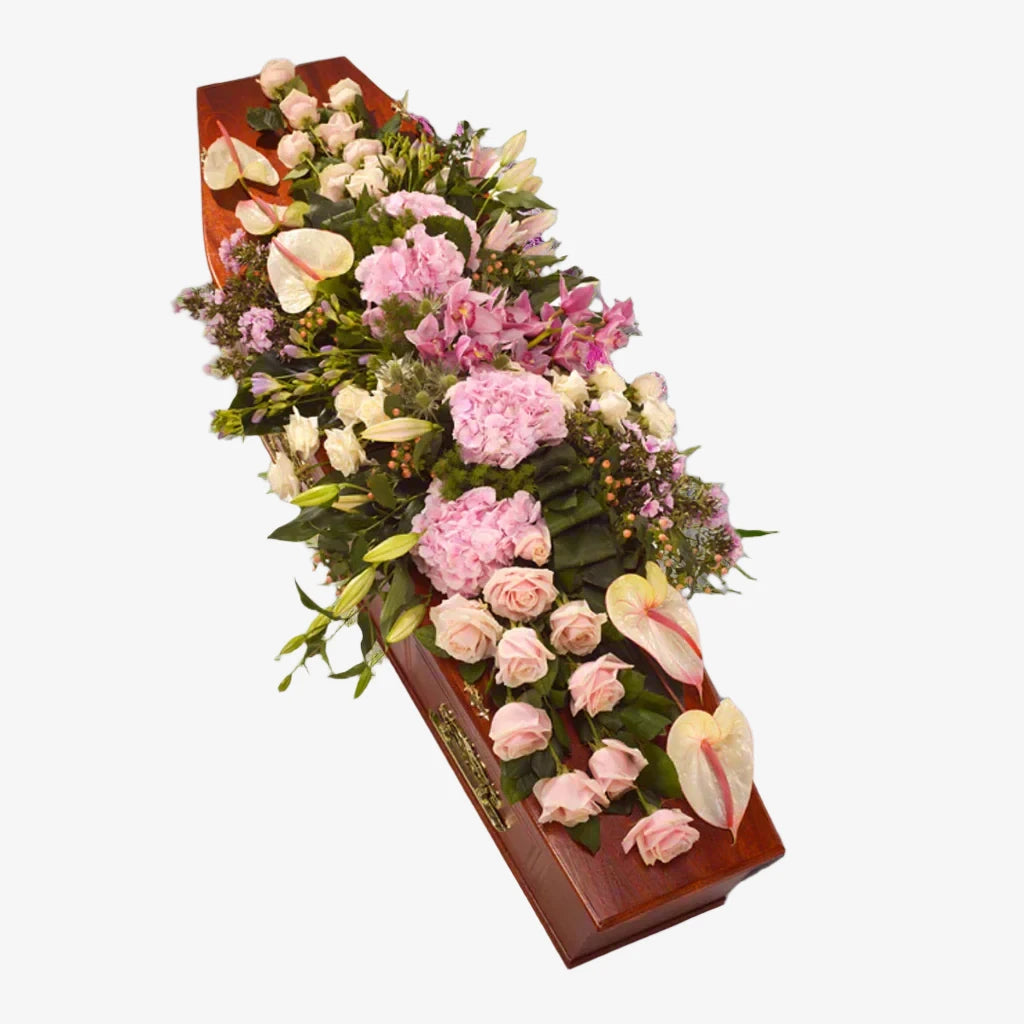 Contemporary Casket Spray - Magnolia the Florist This contemporary casket spray features a modern design filled with a variety of flowers in pink tones, including Roses, Hydrangea, Anthurium, and lilies. This elegant arrangement adds a touch of sophistication to any funeral service. If you cannot find what you want on our site, please call our sales team, we're always happy to assist you. This item requires 5 days notice to order.  1