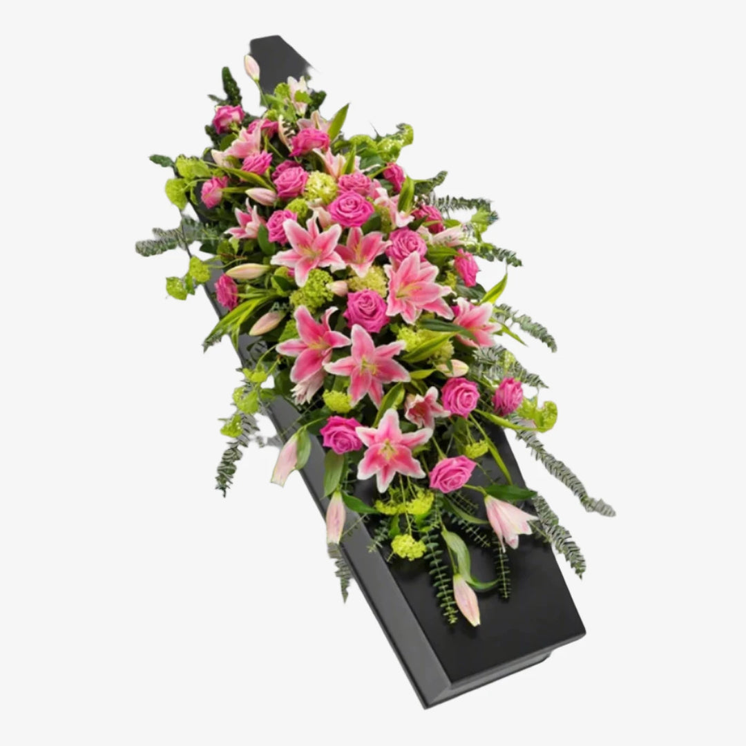 Rose & Lily Casket Spray - Magnolia the Florist This elegant casket spray features a delicate mix of lilies, roses, and foliage. The arrangement is a beautiful and heartfelt way to honour and pay tribute to your loved one. You also have the colour options of White or Pink. The image shows the Pink option. If you cannot find what you want on our site, please call our sales team, we're always happy to assist you. This item requires 5 days notice to order.  1