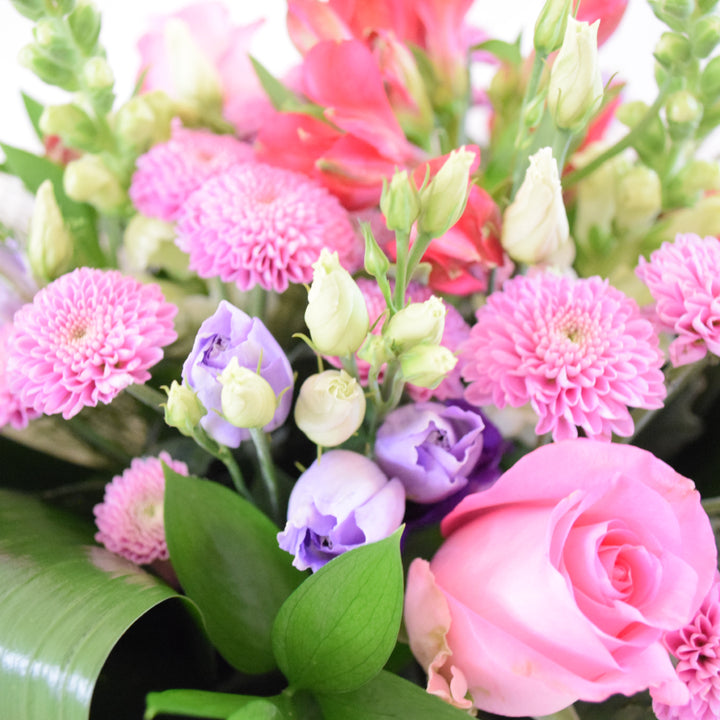 Chelsea Bouquet - Magnolia the Florist Our Chelsea Bouquet from Magnolia the Florist, is a stunning combination of pink, white, and a hint of purple flowers, including roses, antirrhinum, lisanthus, alstromeria, and chrysanthemum. It is perfect for any occasion.  3