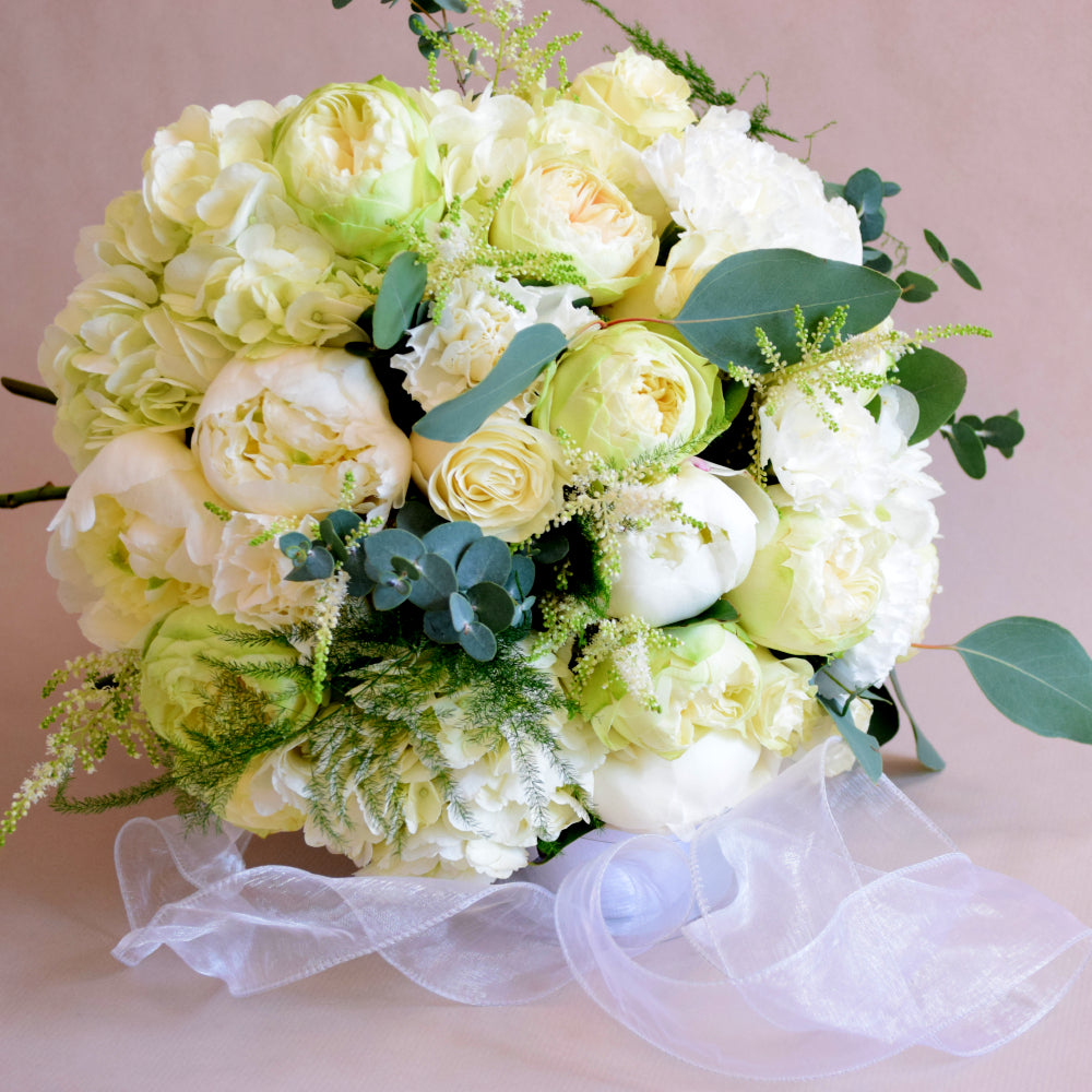 Bridesmaid Posy - Magnolia the Florist The roses take centre-stage in this small Bridesmaid posy, with the stems cut short in compact, round designs for an effortlessly stylish, deeply romantic look  1