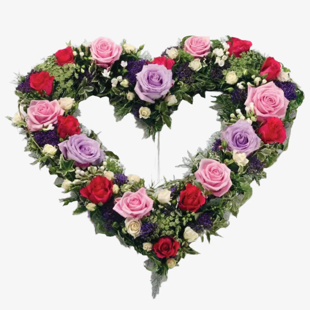 Garden Heart - Magnolia the Florist Large and small-headed Roses and Spray Roses in lilac, cream, cerise and pastel pink are nestled into a 17" open heart shape finished with sprigs of scented Rosemary. If you cannot find what you want on our site, please call our sales team, we're always happy to assist you This item requires 2 days notice to order.  1