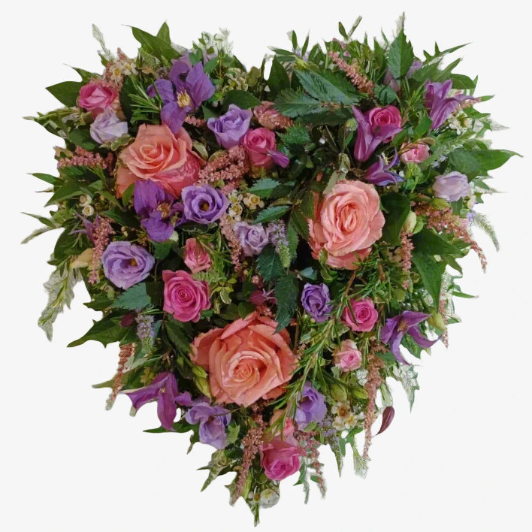 Cottage Garden Heart - Magnolia the Florist A 13" heart-shaped design with pink-toned large-headed roses, Pink spray roses, Lisianthus, rosemary and foliage.. If you cannot find what you want on our site, please call our sales team, we're always happy to assist you This item requires 3 days notice to order.  1