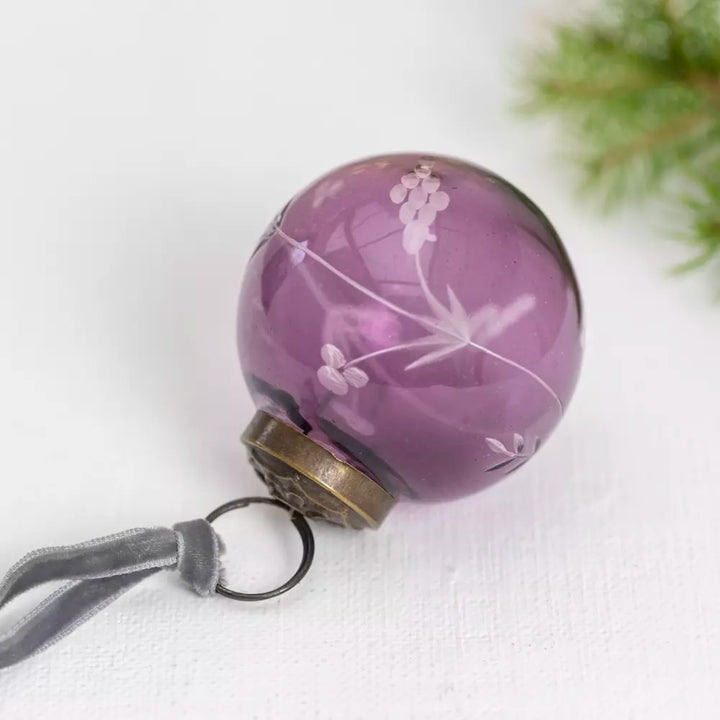 Etched Round Decoration  - Purple - 5cm - Magnolia the Florist Instantly make your Christmas tree more fun with this stylish purple glass bauble. With detailed hand etching that catches the light beautifully, this 5cm decoration packs a larger than expected punch and adds subtle elegance to your festive display. This charming little bauble will hang effortlessly in your tree, quietly helping to make Christmas, Christmas. Dimensions: 5 cm - Glass  3