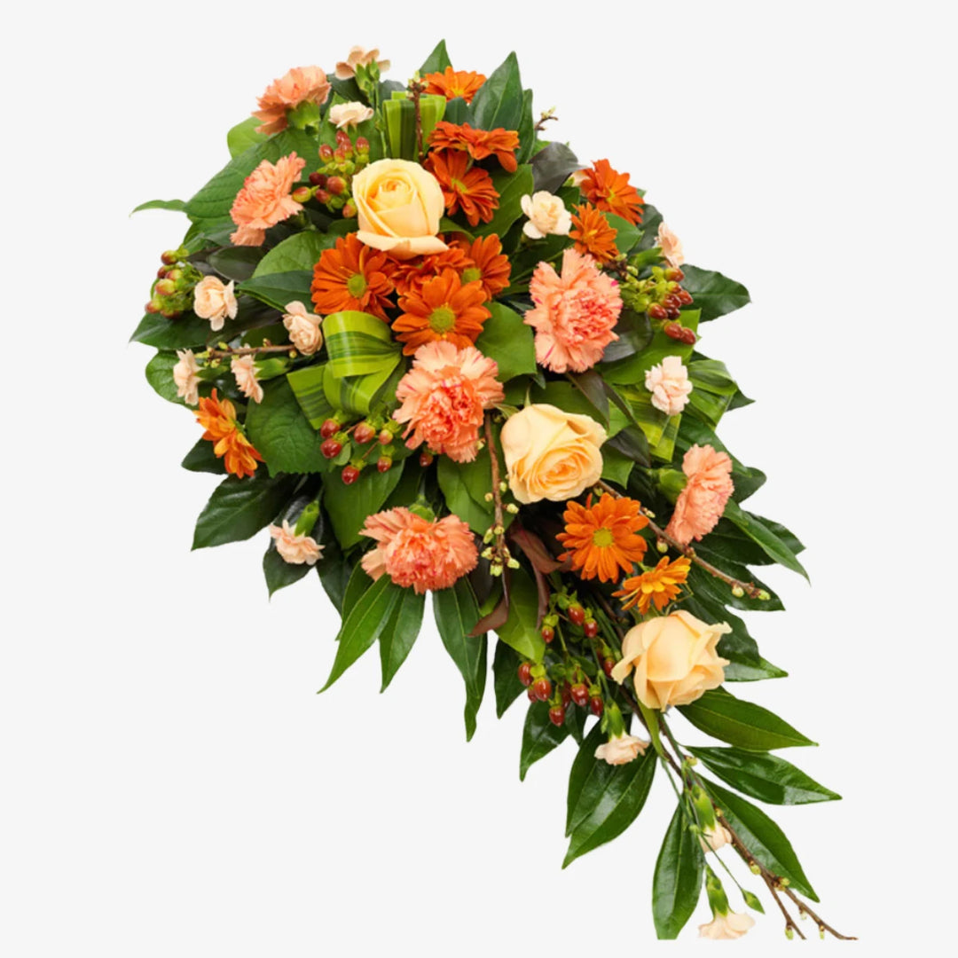 Orange Single-Ended Spray - Magnolia the Florist This single-ended funeral spray in orange tones features a beautiful mix of roses, carnations, and other seasonal flowers and foliage. With its elegant and vibrant design, it serves as a heartfelt tribute to your loved one. The perfect way to honour and celebrate their life. If you cannot find what you want on our site, please call our sales team, we're always happy to assist you This item requires 2 days notice to order.  1