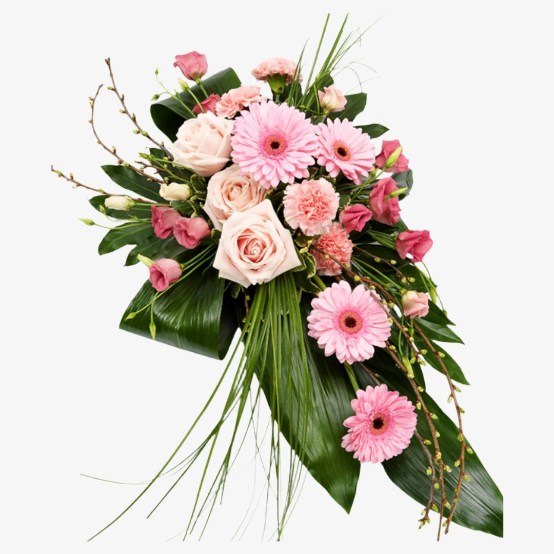 Pink Single-Ended Spray - Magnolia the Florist This beautiful single-ended funeral spray in pink tones is a thoughtful and elegant way to honour your loved one. Featuring roses, mini gerbera, and other seasonal mix flowers and foliage. If you cannot find what you want on our site, please call our sales team, we're always happy to assist you This item requires 2 days notice to order.  1