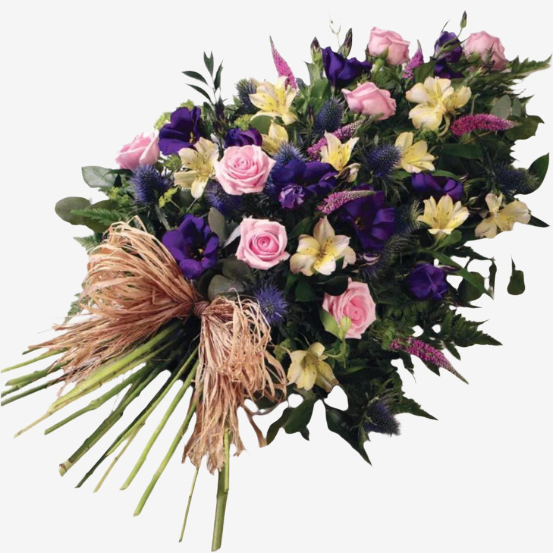 Woodland Single-Ended Spray - Magnolia the Florist Large-headed Roses, Lisianthus, Alstroemeria and Veronica in pretty pinks, lilacs and creams are set off by blue Eryngium, luxury foliages and a raffia bow to create this woodland single-ended spray. Single Ended Sprays have an approximate length of 55 cm. If you cannot find what you want on our site, please call our sales team, we're always happy to assist you This item requires 2 days notice to order.  1