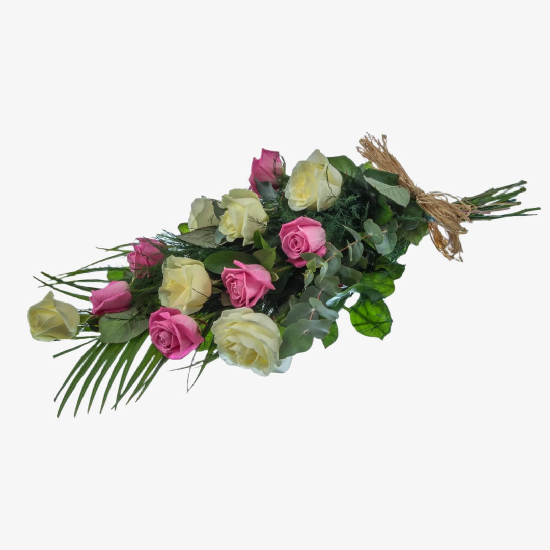 12 Rose Hand-Tied Sheaf - Magnolia the Florist 12 large-headed Roses are presented with a selection of foliage to create this classic Rose sheaf. The image shows the colour option of White and Pink Roses, although other options are available. Please select your colour option below. If you cannot find what you want on our site, please call our sales team, we're always happy to assist you. This item requires 1 day notice to order. Appox lenght 45cm  1