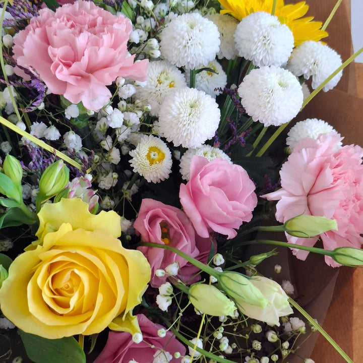 Lilford Bouquet - Magnolia the Florist The Lilford Bouquet is an expertly crafted hand-tied arrangement showcasing a refined blend of Germini, Roses, Alstroemeria, Eustoma, Carnation, Gyp, Chrysanthemums, and Statice in harmonious shades of pink, yellow, and white. Finished with lush greenery, this bouquet balances texture and colour to create a sophisticated, elegant statement suitable for any occasion.  3