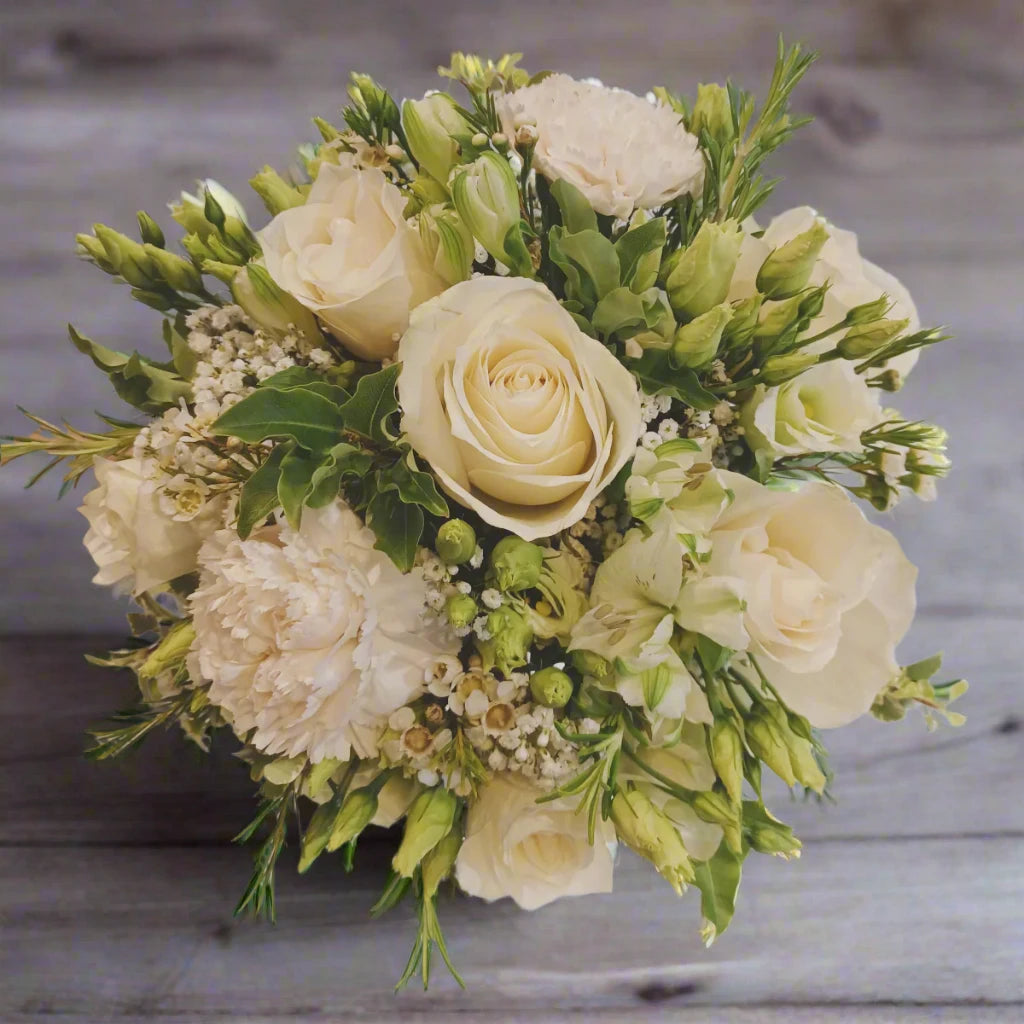 Bridesmaid Bouquet Knot - Magnolia the Florist A petit bridesmaid bouquet featuring the best blooms the season has to offer.Select your colour palette and we’ll craft a stunning design just for you! Please note this item requires a minimum 1-day notice to order.  1