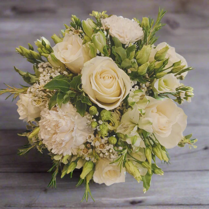 Bridesmaid Bouquet Knot - Magnolia the Florist A petit bridesmaid bouquet featuring the best blooms the season has to offer.Select your colour palette and we’ll craft a stunning design just for you! Please note this item requires a minimum 1-day notice to order.  1