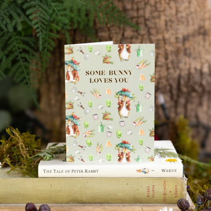 Some-Bunny Loves You (Benjamin Bunny) Card - Magnolia the Florist A sweet Benjamin Bunny mini card with a gold‑foiled message — a lovely way to add a little love to your flowers. Printed on beautifully textured, fully recyclable card. Size is 90 × 120 mm • Blank inside • Includes white envelope  1