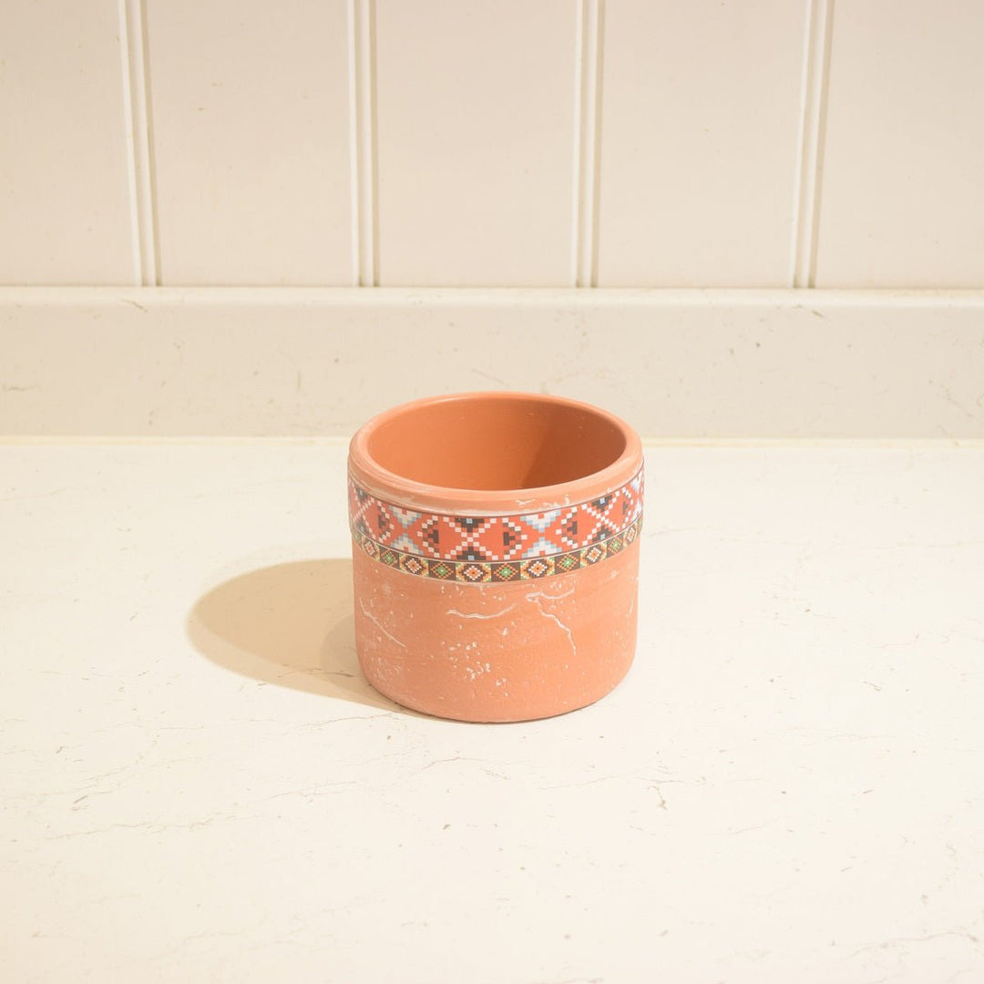 "Aztec" Terracotta Pot -Small - Magnolia the Florist This "Aztec" Terracotta Pot is the ideal accent piece for any indoor space. It has a unique Aztec-style motif and measures 9 cm high by 11 cm wide, so it can comfortably hold a 9 cm wide pot. The terracotta pot is glazed on the inside, making it suitable for indoor use only.  2