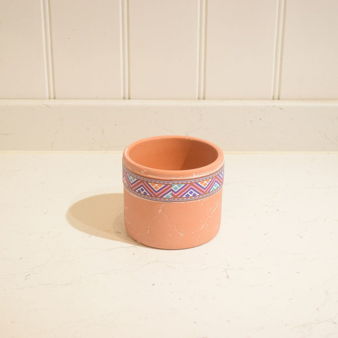"Aztec" Terracotta Pot -Small - Magnolia the Florist This "Aztec" Terracotta Pot is the ideal accent piece for any indoor space. It has a unique Aztec-style motif and measures 9 cm high by 11 cm wide, so it can comfortably hold a 9 cm wide pot. The terracotta pot is glazed on the inside, making it suitable for indoor use only.  3