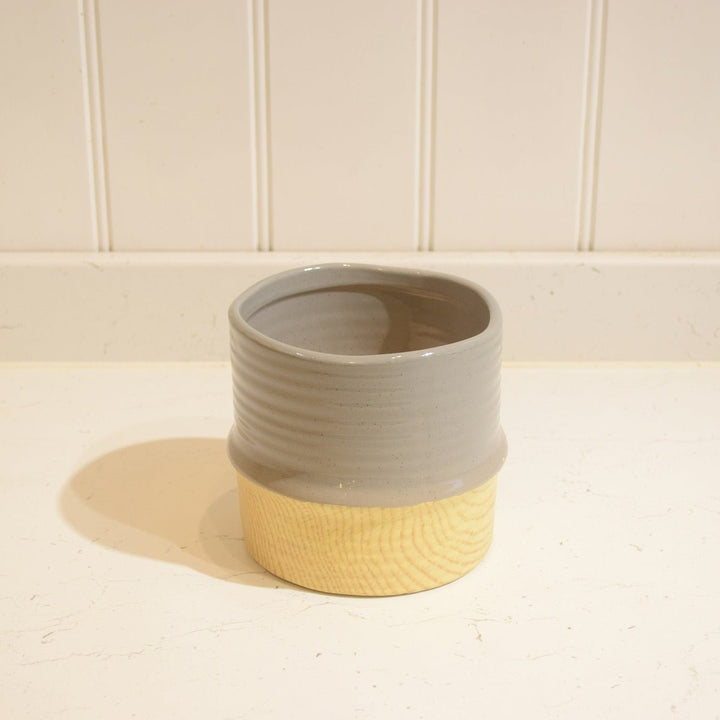 Bamboo Effect Ceramic Pot - Magnolia the Florist A beautiful bamboo effect pot with a coloured top band. The approximate size is 14 centimeters heigh by 13 centimeters. The opening approximately 12cm.  2