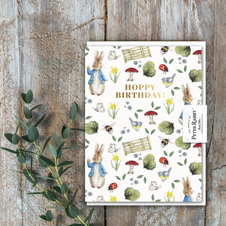 Hoppy Birthday (Peter Rabbit) Card - Magnolia the Florist Celebrate their special day with this charming Hoppy Birthday Peter Rabbit Card, featuring the beloved Beatrix Potter character. Beautifully illustrated and environmentally friendly, this cello-free card is the perfect finishing touch to a birthday gift Size is 90 × 120 mm • Blank inside • Includes white envelope  2